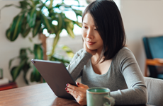 Smiling woman looking at tablet device