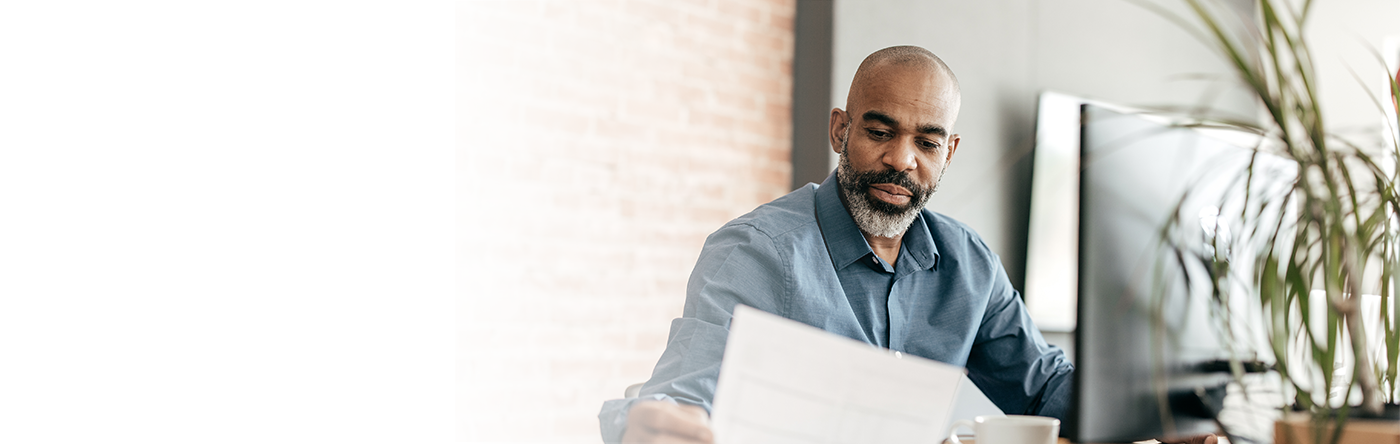 Businessman sitting looking at papers