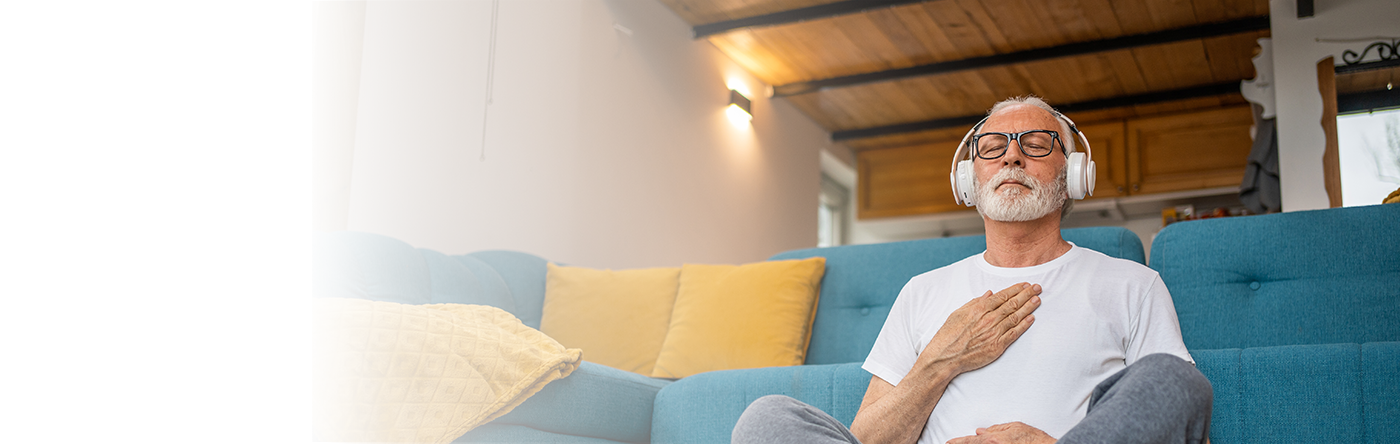 senior man sitting on floor meditation