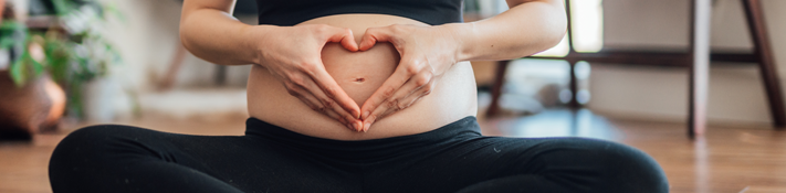 Healthy Pregnancy hands in heart shape over stomach